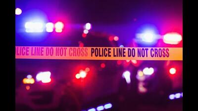 Accident or crime scene cordon tape, police line do not cross. It is nighttime, emergency lights of police cars flashing blue, red and white in the background (Getty Images/iStockphoto)