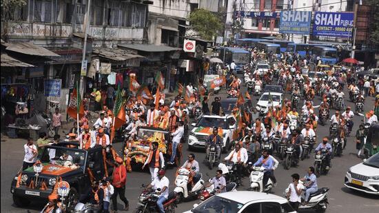 BJP candidates Kantibhai Ballar and Kumarbhai Kanani with party supporters on their way to file the nomination form for the upcoming Gujarat assembly elections, in Surat on Monday. (ANI)