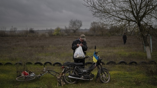Russia-Ukraine War: A resident collects a food donation in Novokyivka, southern Ukraine.(AP)