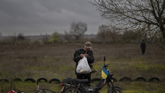 Russia-Ukraine War: A resident collects a food donation in Novokyivka, southern Ukraine.(AP)