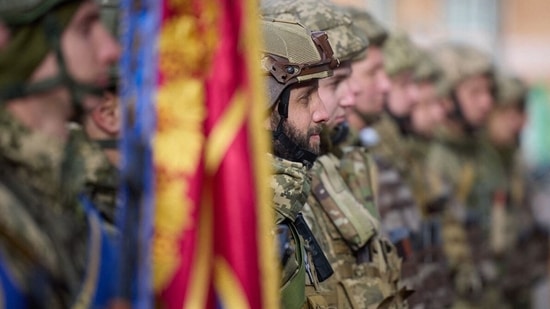 Russia-Ukraine War: Ukrainian serviceman standing in attention during Ukrainian President Volodymyr Zelensky's visit to the newly liberated city of Kherson.(AFP)