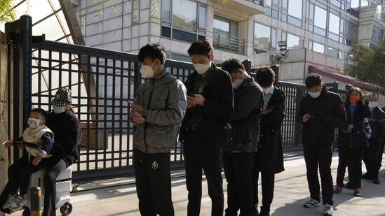 Covid In China: Residents line up outside a community for Covid test in Beijing.(AP)