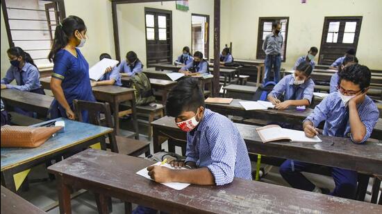 Students maintain social distancing as they attend a class after schools reopened after lockdown in Assam in September 2020. (PTI File Photo)