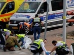 Members of an emergency response team and Israeli forces are seen. 