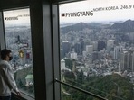 North Korea: A man looks at the view near a window (R) displaying the distance to the North Korean capital, Pyongyang, at the landmark Namsan Tower in Seoul. North Korea: A man looks at the view near a window (R) displaying the distance to the North Korean capital, Pyongyang, at the landmark Namsan Tower in Seoul.