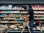 An employee stocks refrigerated items at a Grocery Outlet store in Pleasanton, Calif., on Thursday.(AP file)