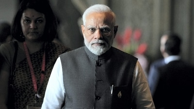 Prime Minister Narendra Modi walks during the G20 Summit in Bali, Indonesia, on Tuesday. (AP) Prime Minister Narendra Modi walks during the G20 Summit in Bali, Indonesia, on Tuesday. (AP)