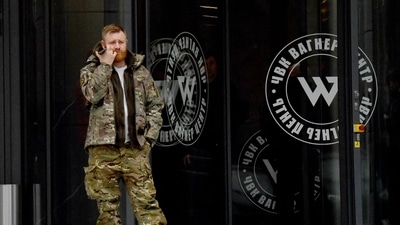 Russia-Ukraine War: A man wearing military camouflage stands at the entrance of the 'PMC Wagner Centre'. (AFP) Russia-Ukraine War: A man wearing military camouflage stands at the entrance of the 'PMC Wagner Centre'. (AFP)