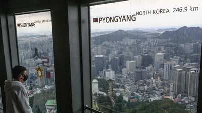 North Korea: A man looks at the view near a window (R) displaying the distance to the North Korean capital, Pyongyang, at the landmark Namsan Tower in Seoul. (AFP) North Korea: A man looks at the view near a window (R) displaying the distance to the North Korean capital, Pyongyang, at the landmark Namsan Tower in Seoul. (AFP)