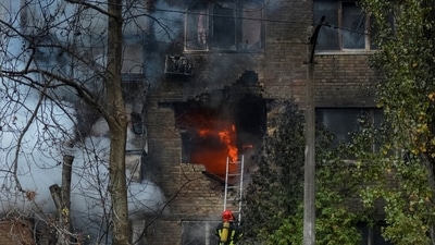 Firefighters work to put out a fire in a residential building hit by a Russian missile strike. (REUTERS)