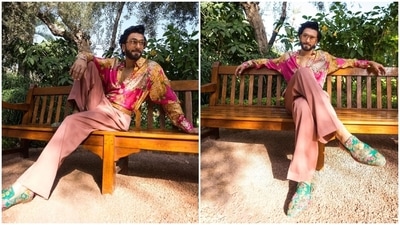 Ranveer accessorised the outfit with a tan Sabysachi logo embellished belt, turquoise floral printed dress shoes, a sleek gold bracelet, diamond ear studs and tinted broad sunglasses. The star embraced retro vibes with the accessories and his side-parted pouf hairdo and rugged beard. (Instagram) Ranveer accessorised the outfit with a tan Sabysachi logo embellished belt, turquoise floral printed dress shoes, a sleek gold bracelet, diamond ear studs and tinted broad sunglasses. The star embraced retro vibes with the accessories and his side-parted pouf hairdo and rugged beard. (Instagram)