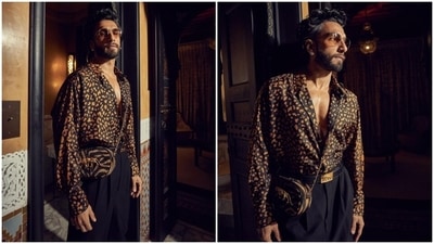 For the second look, Ranveer chose another look by ace-designer Sabyasachi Mukherjee. He wore an oversized collared shirt featuring mustard and black animal print, full-length sleeves and front button closures. Lastly, black high-waisted pants with front pleats and baggy fitting completed the ensemble. (Instagram) For the second look, Ranveer chose another look by ace-designer Sabyasachi Mukherjee. He wore an oversized collared shirt featuring mustard and black animal print, full-length sleeves and front button closures. Lastly, black high-waisted pants with front pleats and baggy fitting completed the ensemble. (Instagram)