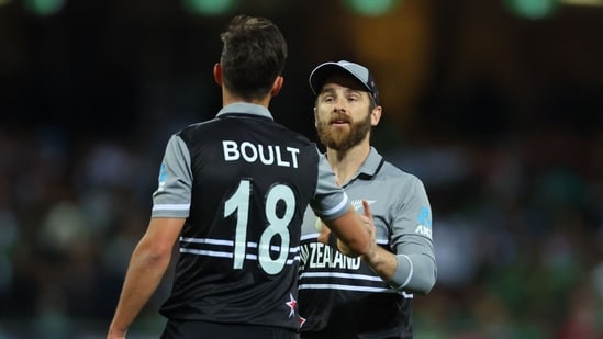 New Zealand's Captain Kane Williamson (R) speaks with New Zealand's Trent Boult during the ICC men's Twenty20 World Cup semis