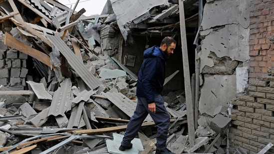 Russia-Ukraine War: Local resident walks on the ruins of a house destroyed by recent shelling in Donetsk.(Reuters)