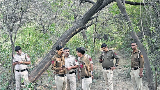 Police officers look for Walkar’s body parts in a forested area in Chhatarpur on Tuesday. (HT Photo)