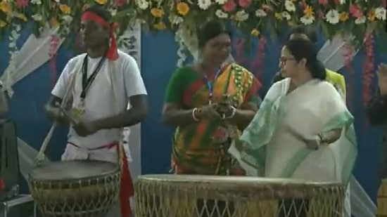 Mamata Banerjee playing the drum at a cultural function in Jhargram, West Bengal. (ANI)