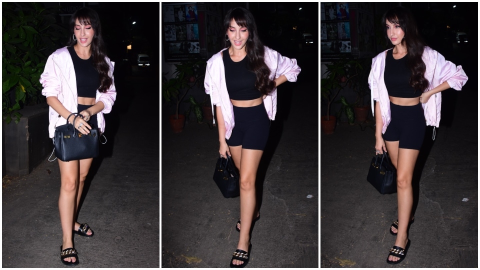 Nora Fatehi styles the all-black ensemble with minimal accessories. (HT Photo/Varinder Chawla)