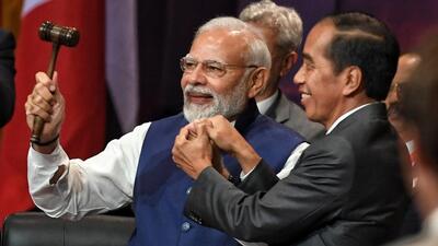 Indonesian President Joko Widodo symbolically hands over the G20 presidency to Prime Minister Narendra Modi. (MEA India) Indonesian President Joko Widodo symbolically hands over the G20 presidency to Prime Minister Narendra Modi. (MEA India)