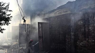Panic gripped the congested Mayapuri area on Tibba Road after three adjoining hosiery waste godowns went up in flames on Tuesday morning. (Gurpreet Singh/HT)