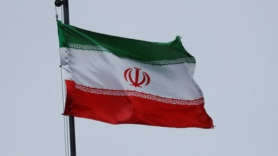 FILE PHOTO: A national Iranian flag waves in the wind over a building of the Iranian embassy. (REUTERS)
