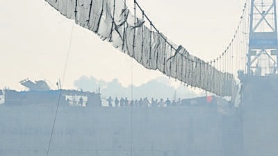 Days after it was reopened following renovation, the suspension bridge on the Machchu river in Gujarat’s Morbi town collapsed on October 30, killing 135 people. (AP) Days after it was reopened following renovation, the suspension bridge on the Machchu river in Gujarat’s Morbi town collapsed on October 30, killing 135 people. (AP)