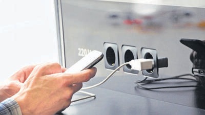 Airport public charger and man's hands with smartphone. Airplane in reflection. Using device in the journey. (Getty Images/iStockphoto) Airport public charger and man's hands with smartphone. Airplane in reflection. Using device in the journey. (Getty Images/iStockphoto)