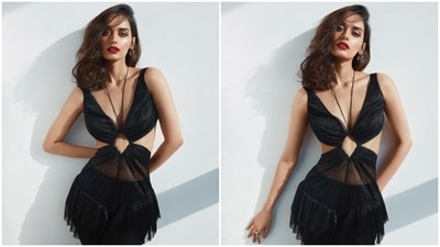 Manushi Chhillar styles her cut-out black dress with a ravishing red pout and dewy skin. (Instagram) Manushi Chhillar styles her cut-out black dress with a ravishing red pout and dewy skin. (Instagram)