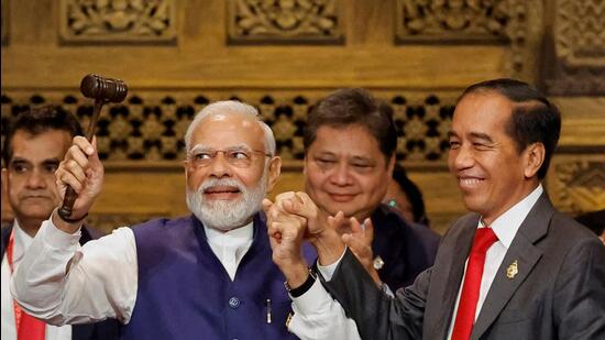 Indonesia’s President Joko Widodo hands over the G20 gavel to Prime Minister Modi in Bali. (AFP)