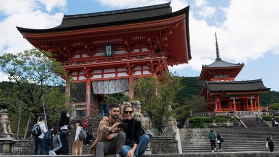 A man and woman pose for a selfie by the entrance of Kiyomizu-dera temple in Kyoto. Japan. (Photo by Fred MERY / AFP)
