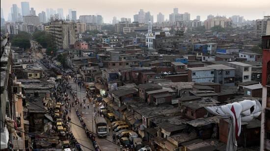 Mumbai, India - April 1, 2020: Small industries workers lineup for the food packets at Dharavi during restrictions on citizens' movement on account of Section 144 due to COVID 19 pandemic in Mumbai, India, on Wednesday, April 1, 2020. (Photo by Satish Bate/Hindustan Times) (Satish Bate/HT Photo)