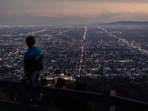 World Population: A boy takes in the view of the Los Angeles skyline.(AP) World Population: A boy takes in the view of the Los Angeles skyline.(AP)