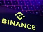 Binance logo and stock graph are displayed.