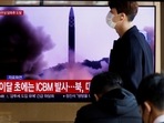 North Korea: A man walks past a TV broadcasting a news report, on North Korea firing a missile.