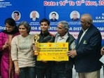 Young Divyansh (centre) poses with the trophy in Noida on Thursday.(BAI) Young Divyansh (centre) poses with the trophy in Noida on Thursday.(BAI)