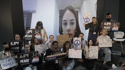 Center for Civil Liberties Oleksandra Matviychuk, appears on screen as activists pose for photos with her at the COP27 U.N. Climate Summit, Thursday, Nov. 17, 2022, in Sharm el-Sheikh, Egypt. (AP) Center for Civil Liberties Oleksandra Matviychuk, appears on screen as activists pose for photos with her at the COP27 U.N. Climate Summit, Thursday, Nov. 17, 2022, in Sharm el-Sheikh, Egypt. (AP)