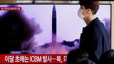 North Korea: A man walks past a TV broadcasting a news report, on North Korea firing a missile. (Reuters)