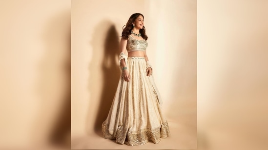 Madhuri Dixit teamed her modern lehenga set with an emerald green neckpiece.(Instagram/@madhuridixitnene)