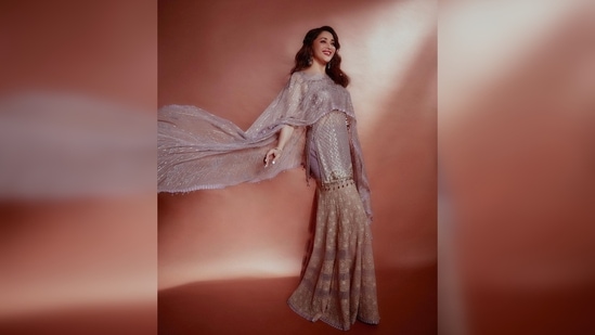Madhuri Dixit's outfit comes with a sharara, a short kurta and a sheer shimmery dupatta.(Instagram/@madhuridixitnene)