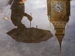 Britain: A woman with an umbrella and the Elizabeth Tower also known as Big Ben are reflected in a puddle in London.(AP) Britain: A woman with an umbrella and the Elizabeth Tower also known as Big Ben are reflected in a puddle in London.(AP)
