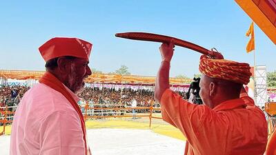 Uttar Pradesh chief minister Yogi Adityanath holds a sword during an electing meeting at Wankaner (ANI PHOTO) Uttar Pradesh chief minister Yogi Adityanath holds a sword during an electing meeting at Wankaner (ANI PHOTO)