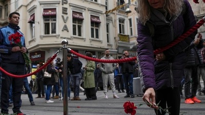 Istanbul Bombing: People put flowers over a memorial placed on the spot of Sunday's explosion. (AP)