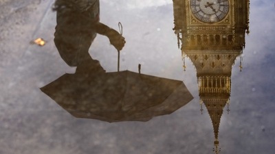 Britain: A woman with an umbrella and the Elizabeth Tower also known as Big Ben are reflected in a puddle in London. (AP) Britain: A woman with an umbrella and the Elizabeth Tower also known as Big Ben are reflected in a puddle in London. (AP)