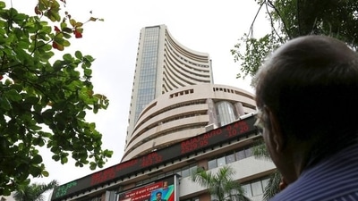 A man looks at a screen across a road displaying the Sensex on the facade of the Bombay Stock Exchange (BSE) building in Mumbai. (REUTERS)