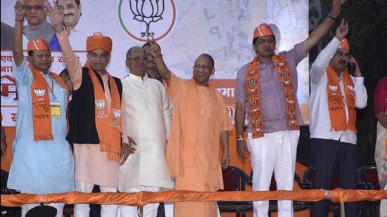 Uttar Pradesh chief minister Yogi Adityanath among others during an election campaign rally for the BJP, ahead of assembly polls, in Surat. (PTI)