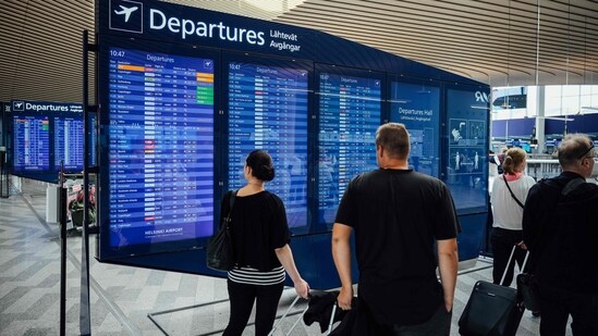 Europeans are starting to cut back on holiday travel. Here's why (Photo by Alessandro RAMPAZZO / AFP)