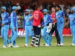 England skipper Jos Buttler and teammate Alex Hales shake hands with Indian players after beating them by 10 wickets during the semifinal match at T20 World Cup