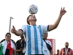 An Argentina fan plays football at the opening of the FIFA fan festival