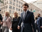 Elizabeth Holmes(middle), founder and former CEO of blood testing and life sciences company Theranos, walks with her mother and partner Billy Evans for her sentence hearing on Friday.(AFP ) Elizabeth Holmes(middle), founder and former CEO of blood testing and life sciences company Theranos, walks with her mother and partner Billy Evans for her sentence hearing on Friday.(AFP )