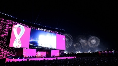 General view of fans at a stage during the opening of the FIFA fan festival as fireworks explode in the background. (REUTERS)