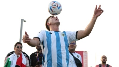 An Argentina fan plays football at the opening of the FIFA fan festival (REUTERS)
